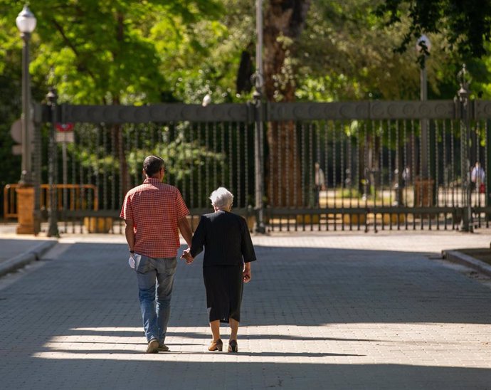 Persona mayor protegido con mascarilla pasea por el Parque de Maria Luisa, en el día en que el Gobierno permite salir a hacer deporte de forma individual y pasear con otra persona con la que se conviva, a determinadas horas