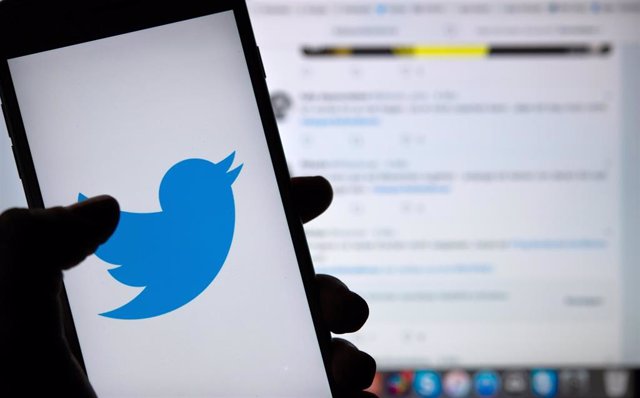 FILED - 23 April 2019, Berlin: A person holds a phone displaying the logo of the Twitter social media platform. Twitter on Monday said it is introducing labels and warnings on some posts containing disputed or misleading information on the coronavirus pan