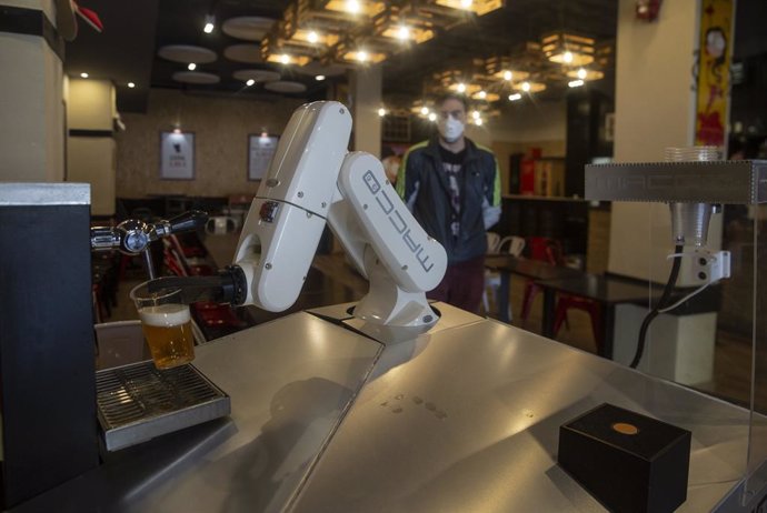 Sevilla.- Coronavirus.-Un bar de Sevilla incorpora un brazo robótico para servir