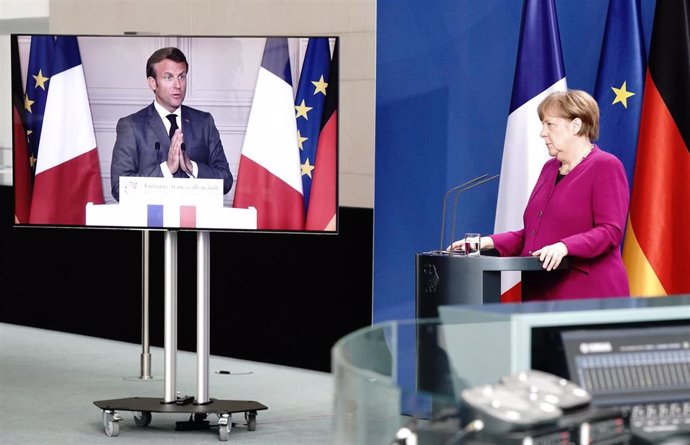 18 May 2020, Berlin: German Chancellor Angela Merkel listens as French President Emmanuel Macron (video-connected) speaks during a joint press conference. Photo: Kay Nietfeld/dpa-Pool/dpa