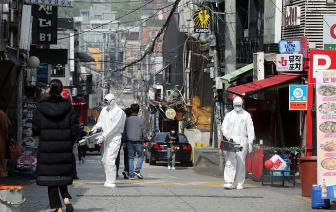 Un grupo e trabajadores desinfectan llas calles del distrito internacional de Itaewon en Seúl, la capital de Corea del Sur.