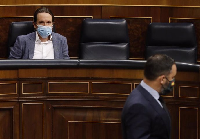 El presidente de Vox, Santiago Abascal, pasando por delante del vicepresidente segundo, Pablo Iglesias, en el Pleno del Congreso