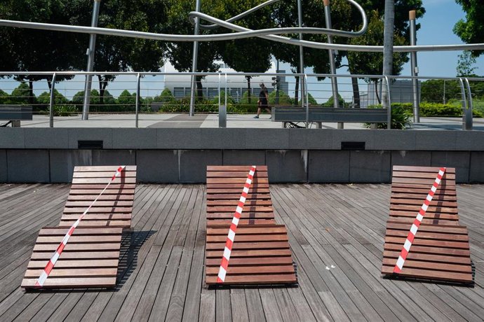 May 5, 2020 - Singapore, Republic of Singapore: During the partial lockdown cordoned off deckchairs remain empty along the waterfront promenade in Marina Bay.