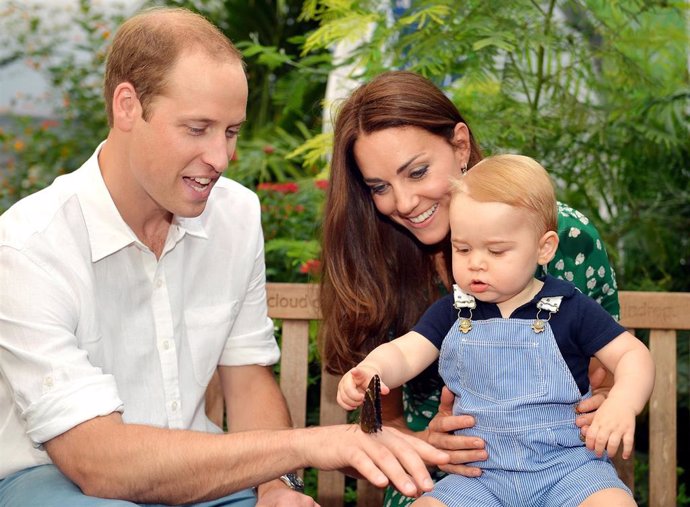 Catherine, Duchess of Cambridge holds Prince George as he points to a butterfly on Prince William