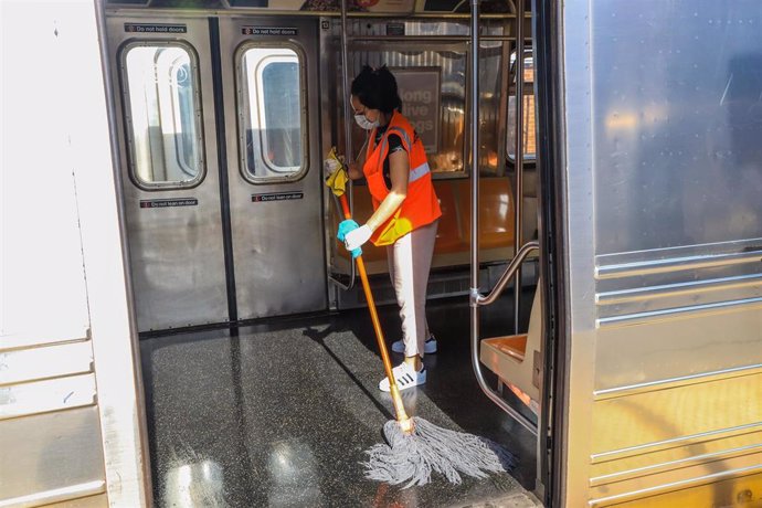 Una trabajadora limpia el suelo de un vagón de metro en Nueva York. 