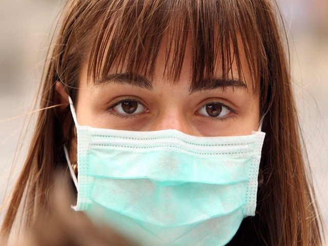 A Woman Wearing A Surgical Mask To Prevent The Transmission Of Airborne Infection , Other Flu Pandemic.  (Photo By Oli Scarff/Getty Images)