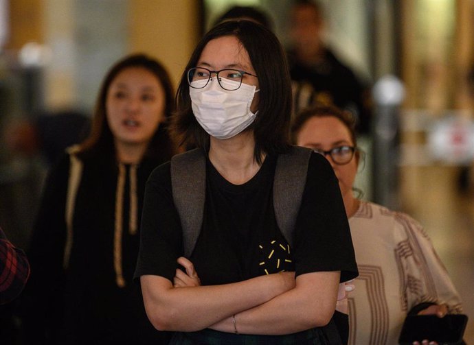 A woman wearing a protective face mask seen in Sydney, Wednesday, March 4, 2020.  (AAP Image/James Gourley) NO ARCHIVING