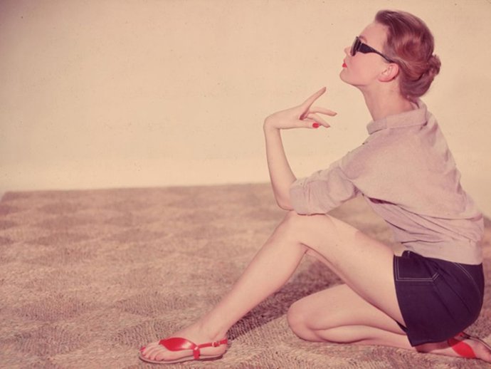 A Woman In Shorts And Sandals Sits Down On A Rafia Mat To Absorb The Rays Of The Sun.  (Photo By Chaloner Woods/Getty Images)
