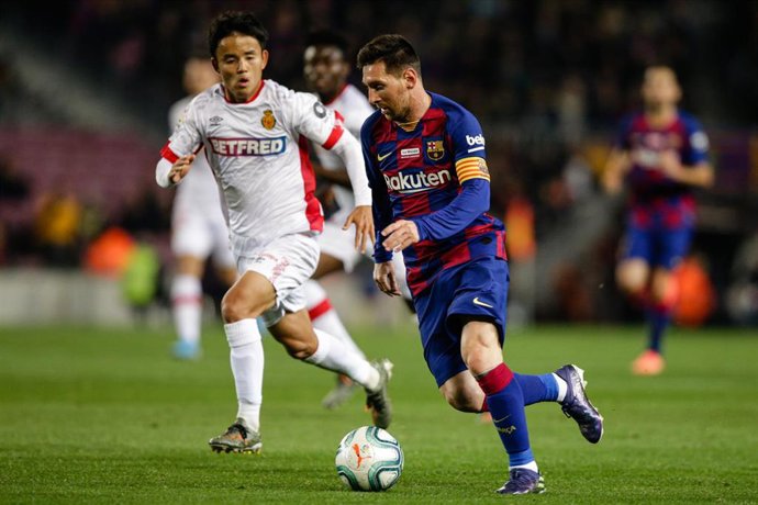 10 Lionel Messi from Argentina of FC Barcelona defended by 26 Take Kubo from Japan of RCD Mallorca during the La Liga Santander match between FC Barcelona and RCD Mallorca in Camp Nou Stadium in Barcelona 07 of December of 2019, Spain.