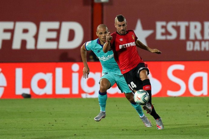Dani Rodriguez of Mallorca and Martin Braithwaite of FC Barcelona in action during the spanish league, LaLiga, football match played between RCD Mallorca and FC Barcelona at Son Moix Stadium in the restart of the Primera Division tournament