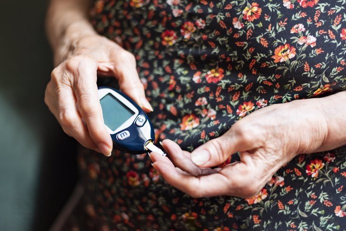 Old lady tracking her glucose levels. Health concept