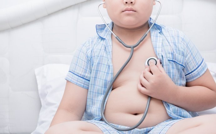 Obese fat boy check heart by stethoscope,