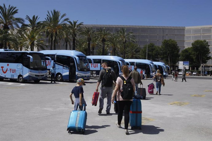 Viajeros procedentes de Alemania suben a los autobuses que les llevarán a su alojamiento tras su llegada al Aeropuerto de Palma dentro del plan piloto de turismo.