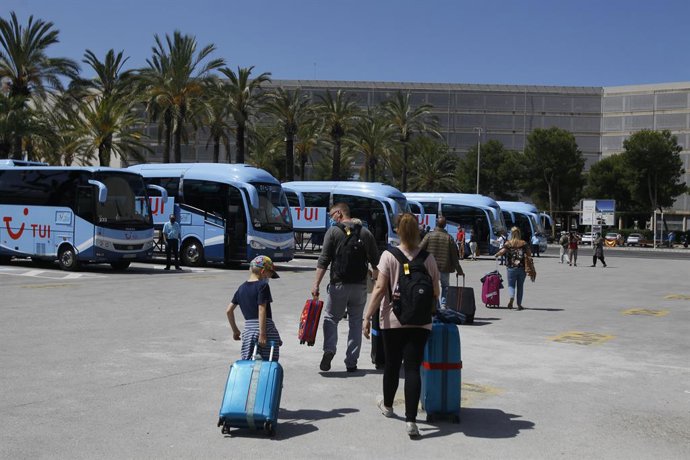 Viajeros procedentes de Alemania suben a los autobuses que les llevarán a su alojamiento tras su llegada al Aeropuerto de Palma dentro del plan piloto de turismo.
