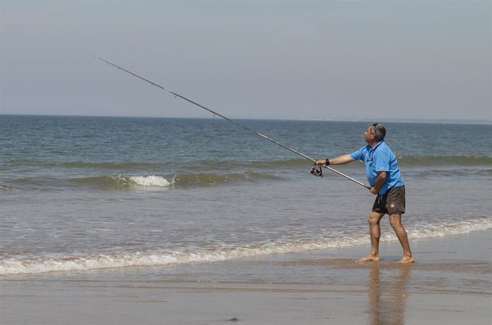 Un hombre pescando en la playa de Punta Umbría, abierta para el paseo y la práctica deportiva como único uso permitido, durante la segunda semana de la Fase 1. En Punta Umbría (Huelva, Andalucía, España), a 21 de mayo de 2020.