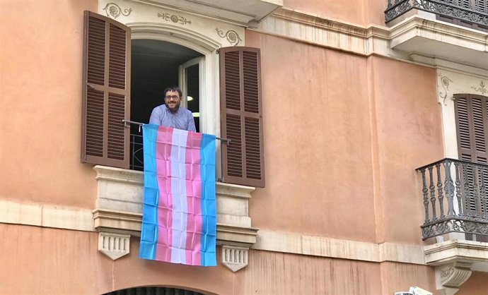 El senador Vicen Vidal, en el balcón de su despacho en el Parlament, con la bandera trans.