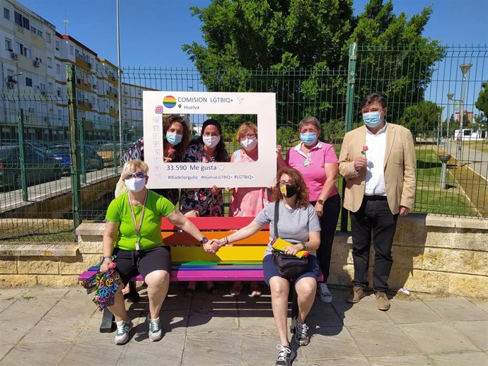 Miembros del colectivo Lgtbiq+, juntao al alcalde de Huelva, Gabriel Cruz, en uno de los bancos.