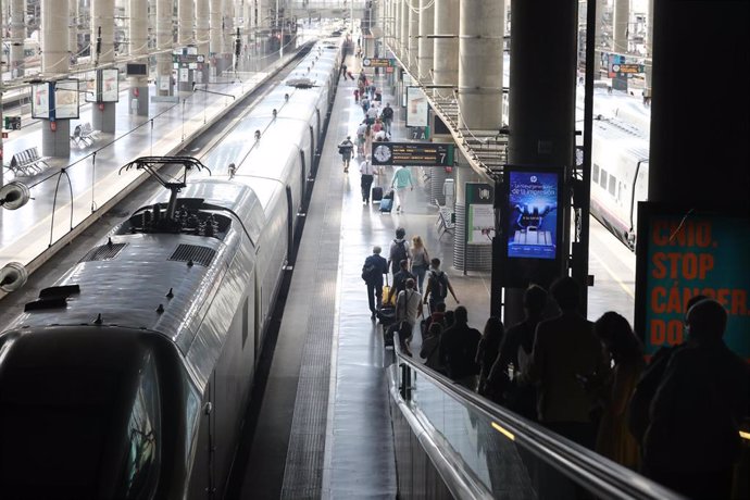 Varios pasajeros con maletas bajan por una cinta transportadora para dirigirse al andén en la estación Madrid-Puerta de Atocha durante el viernes previo al primer fin de semana tras el estado de alarma, en Madrid (España), a 26 de junio de 2020.