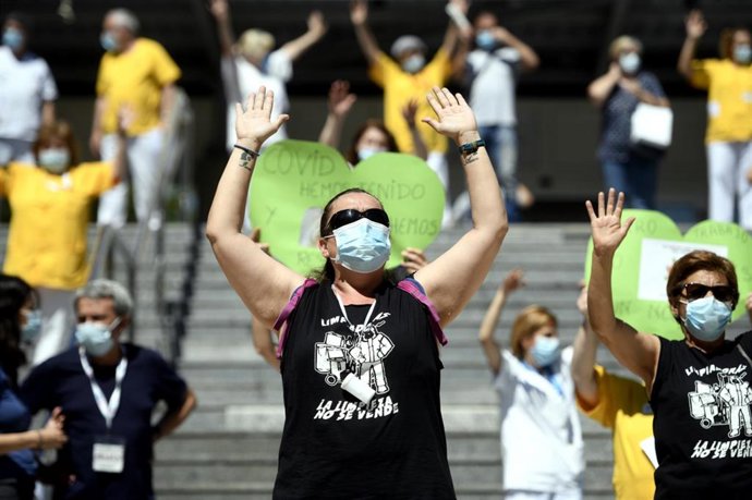 Una trabajadora de limpieza del Hospital Gregorio Marañón con los brazos en alto a las puertas del hospital durante la primera jornada de huelga, en Madrid (España), a 29 de mayo de 2020.