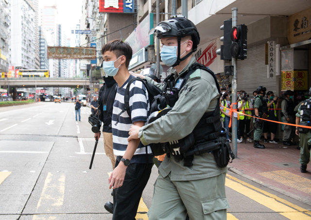 01 July 2020, China, Hong Kong: A police officer arrests a demonstrator during a pro-democracy demonstration on the 23rd anniversary of the establishment of the Hong Kong Special Administrative Region in Hong Kong. 