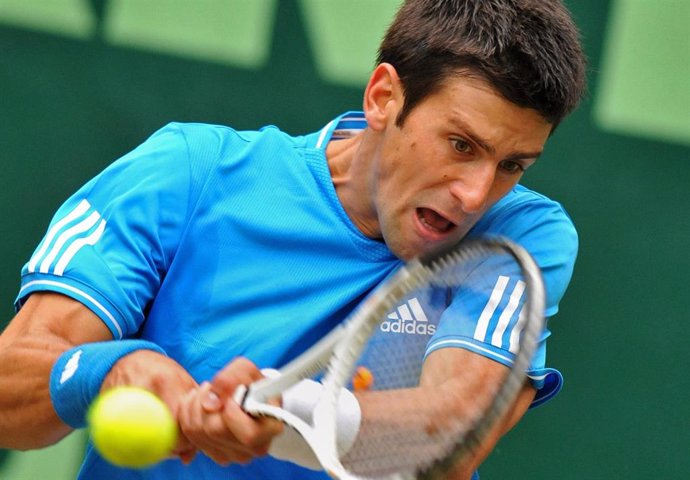 Serbian tennis player Novak Djokovic in action against France's Florent Serra during the 2009 Gerry Weber Open. Djokovic said through his team on Thursday that he had returned a negative coronavirus test after previously being infected