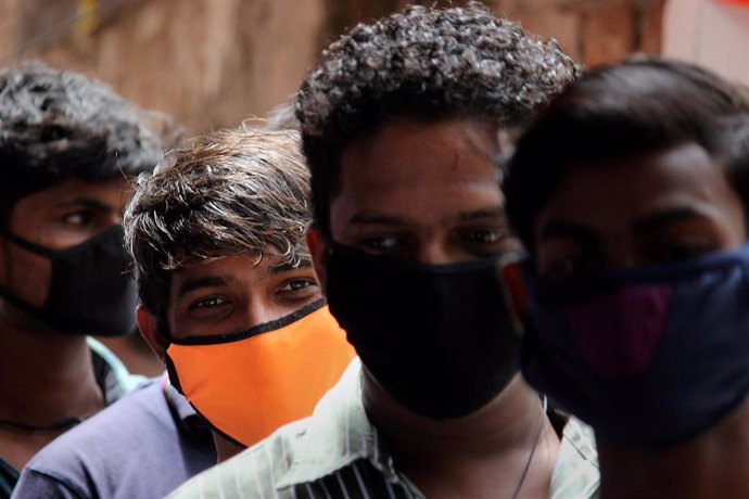 Personas con mascarilla esperan a realizarse el test de la COVID-19 en Bombay
