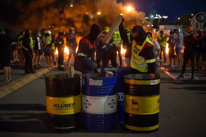 Manifestantes durante una concentración nocturna convocada por el comité de Alcoa San Cibrao, en el entorno de la fábrica de San Cibrao, cortan el acceso a la fábrica con bidones en Lugo, Galicia (España), a 30 de junio