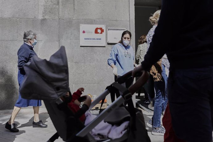 Mujeres esperan en las inmediaciones de la Parroquia Santa María Micaela y San Enrique para recibir ayuda de la Fundación Madrina. En Madrid, (España), a 12 de junio de 2020.