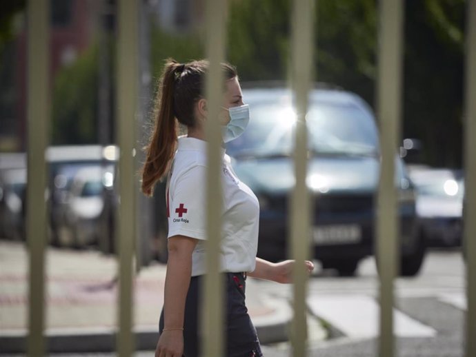 Una voluntaria de Cruz Roja camina por las inmediaciones del Instituto de Educación Secundaria de Mendillorri la zona donde realizarán durante esta tarde pruebas PCR de diagnóstico de COVID-19 a jóvenes de entre 17 y 28 años, en Pamplona, Navarra (Españ