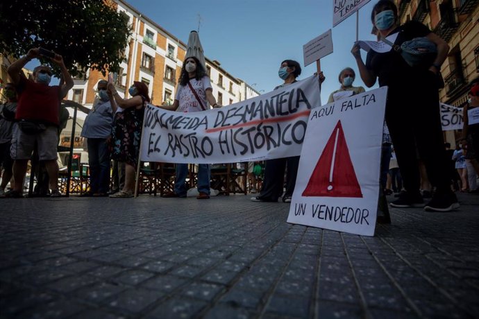 Comerciantes de El Rastro madrileño sostienen pancartas durante la manifestación en la Plaza del Cascorro por tercer domingo consecutivo para exigir sus puestos habituales y recuperar el modelo "histórico" del mercadillo.