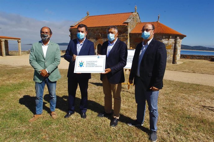 El conselleiro de Cultura e Turismo en funciones, Román Rodríguez, entrega al alcalde de Sanxenxo (Pontevedra), Telmo Martín, el distintivo de municipio de preferente actuación turística.