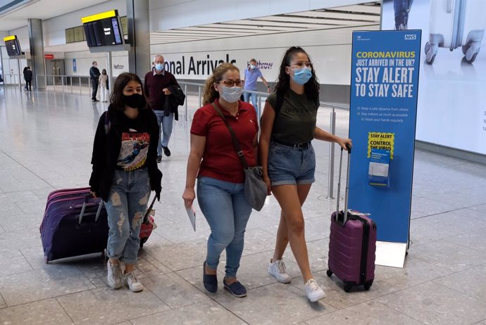 Passengers on a flight from Madrid arrive at Heathrow Airport
