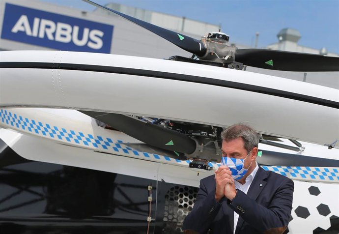 20 July 2020, Bavaria, Donauwoerth: Bavarian Minister-President Markus Soeder wearing a face mask gestures next to an Airbus CityAirbus during his visit to Airbus Helicopters. Photo: Karl-Josef Hildenbrand/dpa