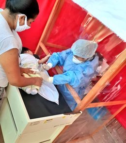 Vacunación de un bebé con medidas de protección por el coronavirus