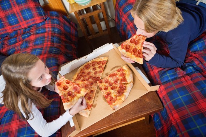 Children Eating Takeout Pizza in Their Bedroom