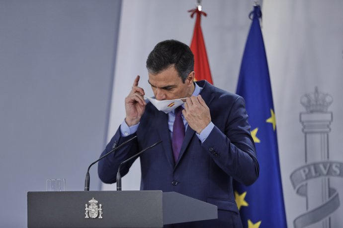 El presidente del Gobierno, Pedro Sánchez, se retira la mascarilla antes de ofrecer la última rueda de prensa posterior a la reunión del Consejo de Ministros y antes de las vacaciones, en Moncloa.