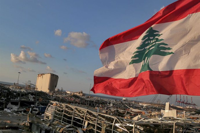 09 August 2020, Lebanon, Beirut: A Lebanese flag flies near the site where a massive explosion blasted the port of Beirut on the afternoon of 04 August which killed at least 158 people, wounded 6000 and displaced some 250,000 to 300,000.
