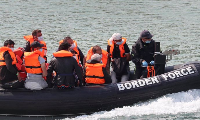 11 August 2020, England, Dover: A group of people thought to be migrants are brought into Dover by Border Force officers following a number of small boat incidents in the English Channel. Photo: Gareth Fuller/PA Wire/dpa