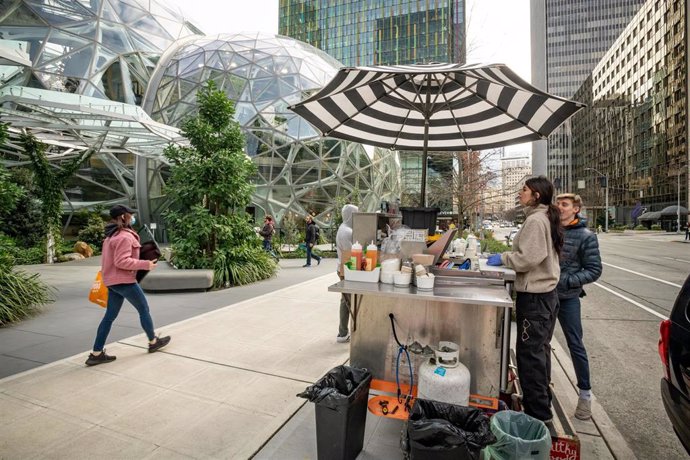March 5, 2020 - Seattle, Washington, United States: The usual crowds of Amazon workers were nowhere to be seen during lunch today at Amazon's Seattle campus. Here Kim Garcia (right) of "Wonderbowl" loks for customers from her food stall next to Amazon's