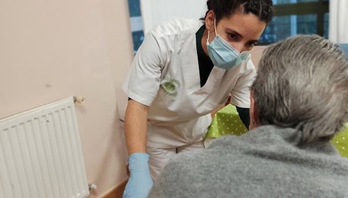 Una trabajadora de la residencia dialoga con uno de los internos