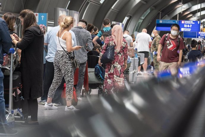 15 August 2020, Hessen, Frankfurt_Main: Passengers wait in a long queue at Frankfurt Airport for a free coronavirus test amid the rising of COVID-19 cases returning from Spain. Photo: Frank Rumpenhorst/dpa