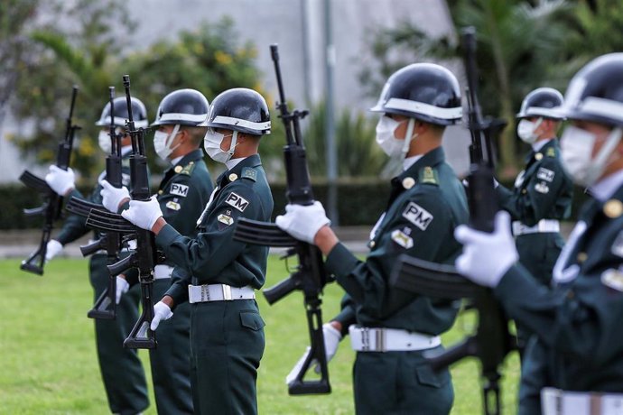 Soldados con mascarillas participan en uno de los actos conmemorativos por el 120 aniversario de la independencia de Colombia.