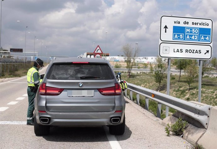 Un guardia civil da el alto a un vehículo en el punto kilométrico en Madrid