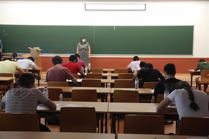 Una profesora vigila una clase mientras estudiantes de las asignaturas troncales de la rama de Ciencias se examinan de las pruebas de la Evaluación de Acceso a la Universidad (EVAU) en la Puerta del Aulario II del Campus de Móstoles de la Universidad Re