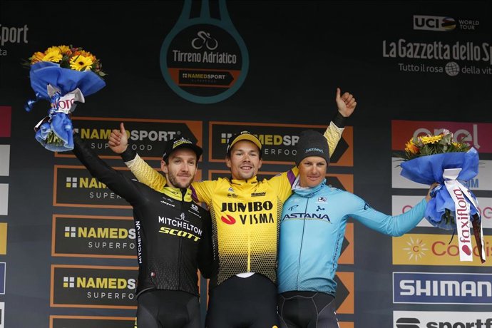 Mitchelton-Scott's British cyclist Adam Yates (L), Team Jumbo-Vism's Slovenian cyclist Primoz Roglic (C) and Astana Pro Team's Danish cyclist Jakob Fuglsang share champagne on the podium of the final stage of the Tirreno-Adriatico