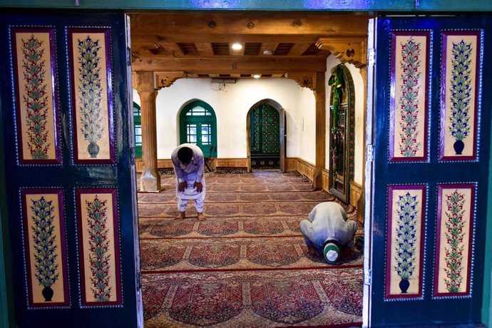 Dos musulmanes rezan en un santuario que ha reabierto sus puertas en India pese al coronavirus. 