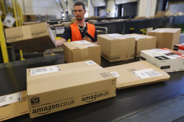 BRIESELANG, GERMANY - SEPTEMBER 04:  A worker prepares packages for delivery at an Amazon warehouse on September 4, 2014 in Brieselang, Germany. Germany is online retailer Amazon's second largest market after the USA. Amazon is currently in a standoff w