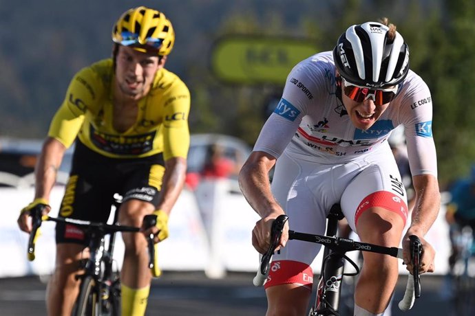 Slovenian cyclist Tadej Pogacar (R) of UAE Team Emirates crosses the finish line to win the 15th stage of the 107th edition of the Tour de France cycling race, 174,5 km from Lyon to Grand Colombier, ahead of compatriot Primoz Roglic of Team Jumbo-Visma.