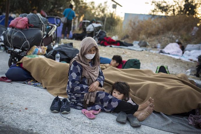 Migrantes del campo de Moria en una cuneta tras quemarse el centro para refugiados