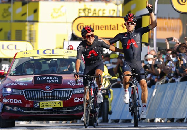 Polish cyclist and stage winner Michal Kwiatkowski of Ineos Grenadiers celebrates with Ecuadorian runner-up and teammate Richard Carapaz after crossing the finish line of the 18th stage of the 107th edition of the Tour de France.